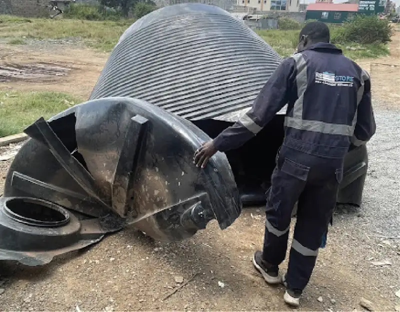 Damaged water tank before repair