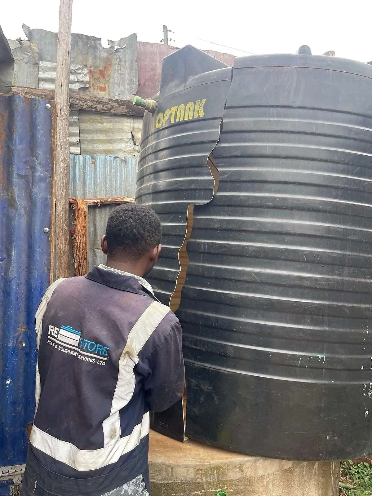 Damaged water tank on site before repair
