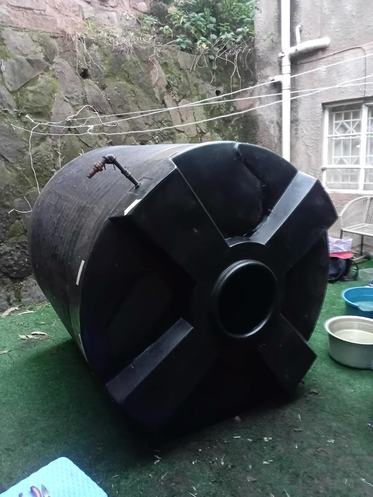 A split black tank welded and restored — after repair
