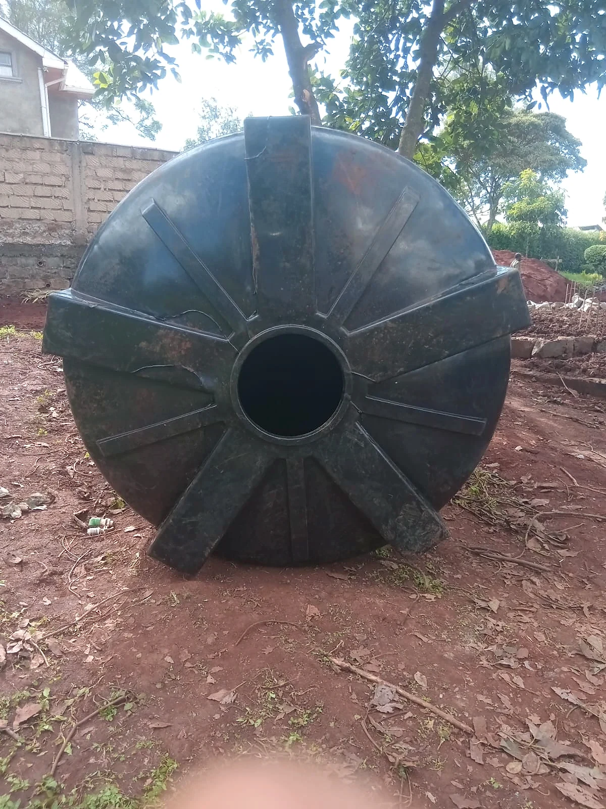 Repaired water tank standing outdoors after service