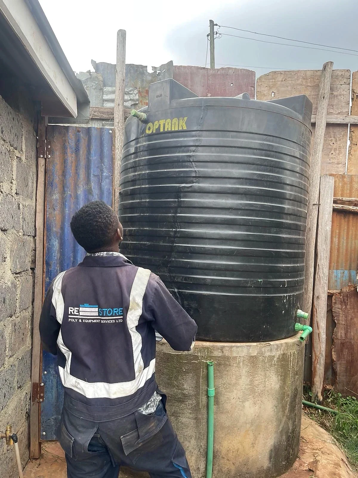 Repaired water tank standing by a wall