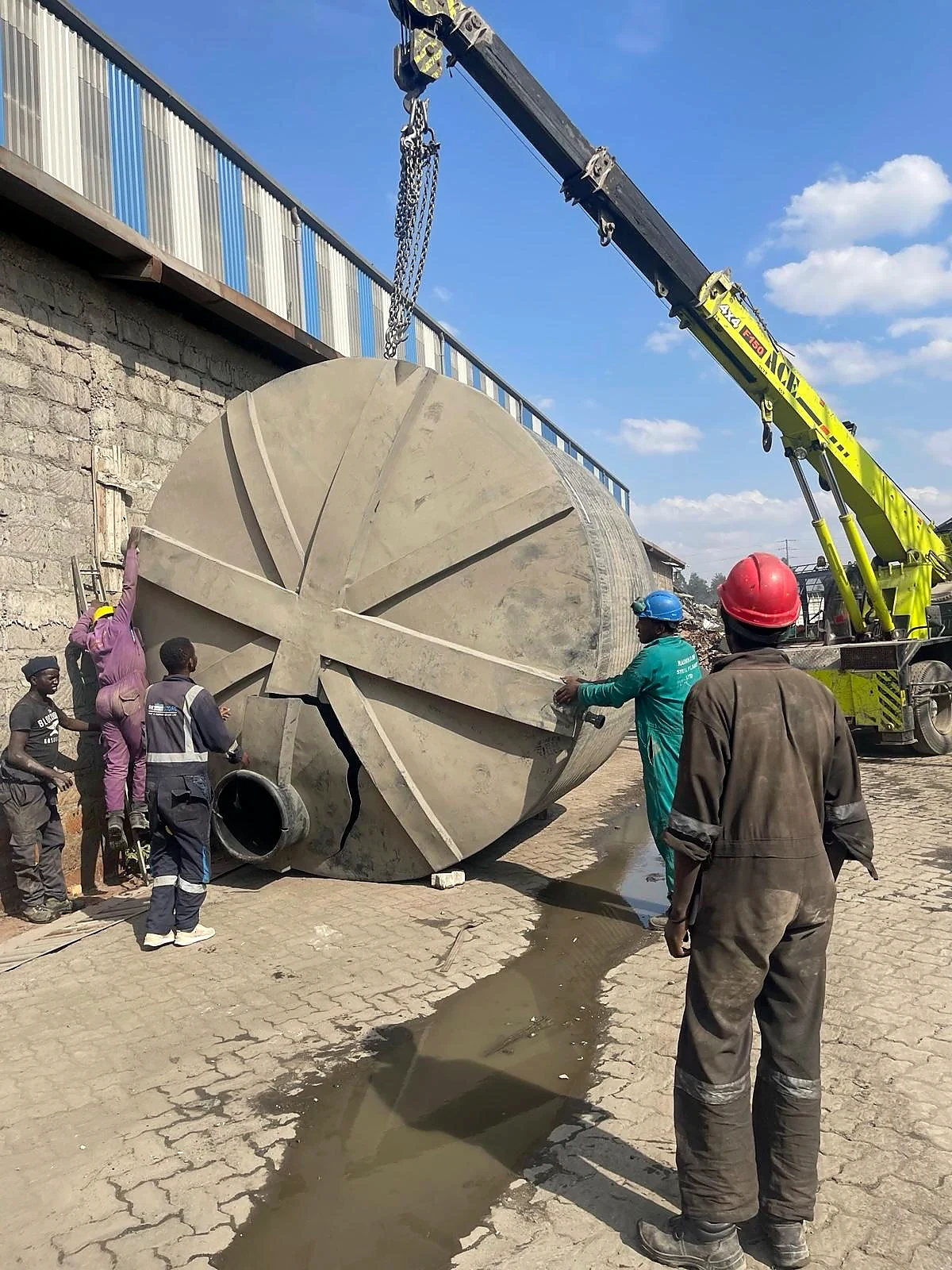 Restore Services team lifting and positioning a damaged water tank for repair
